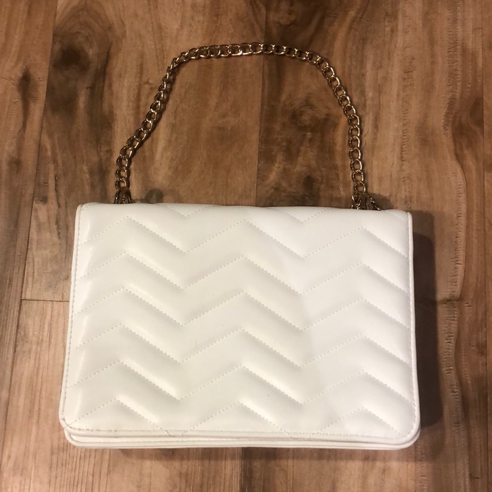 White purse with gold hardware